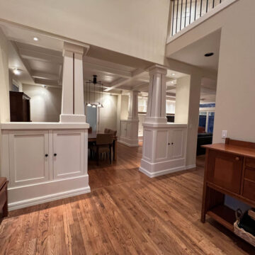 Wilsonville Home featuring high ceilings in the living room and dining room, both adorned with stunning hardwood floors.