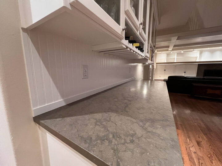 A Wilsonville home with white cabinets and a marble counter top.